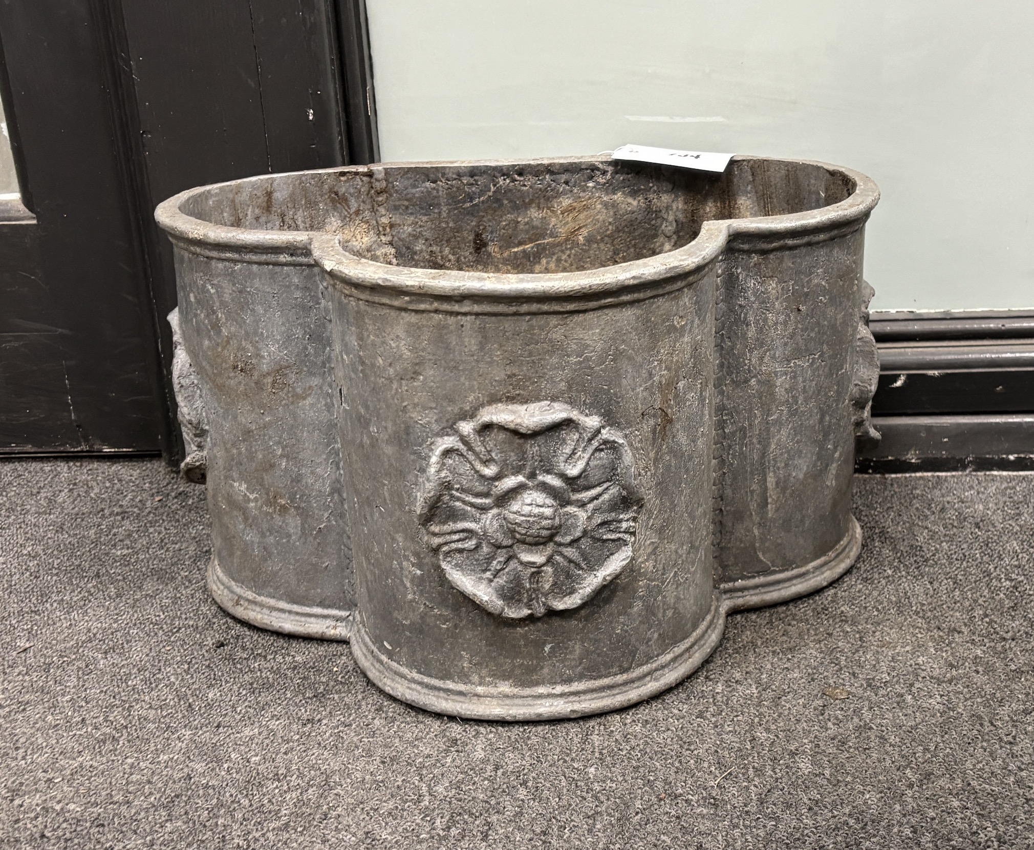 A lead trefoil shaped garden planter, with applied Tudor roses width width 40cm, depth 30cm, height 22cm.